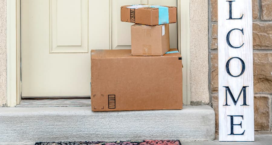 Packages on the doorstep of a home with a welcome sign in Rockford